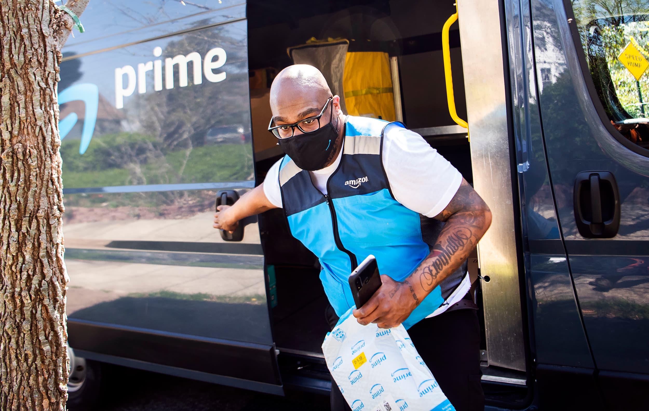 A man delivering a package for Amazon