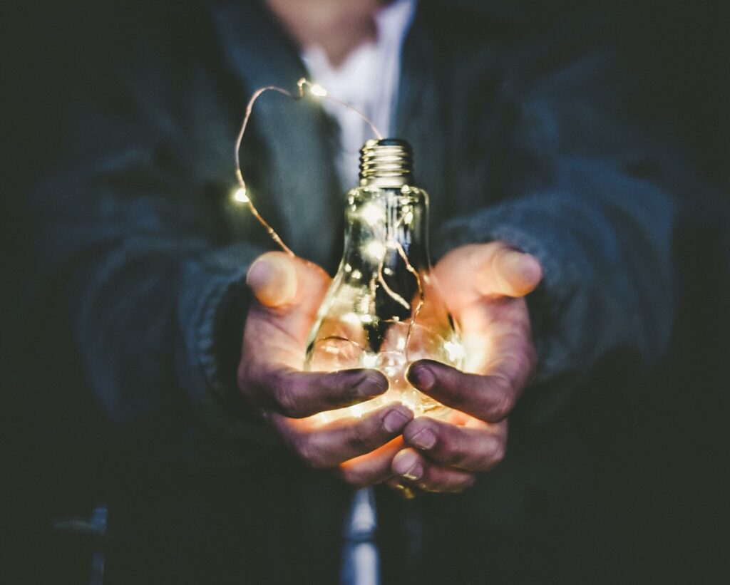 Man holding lightbulb in both hands